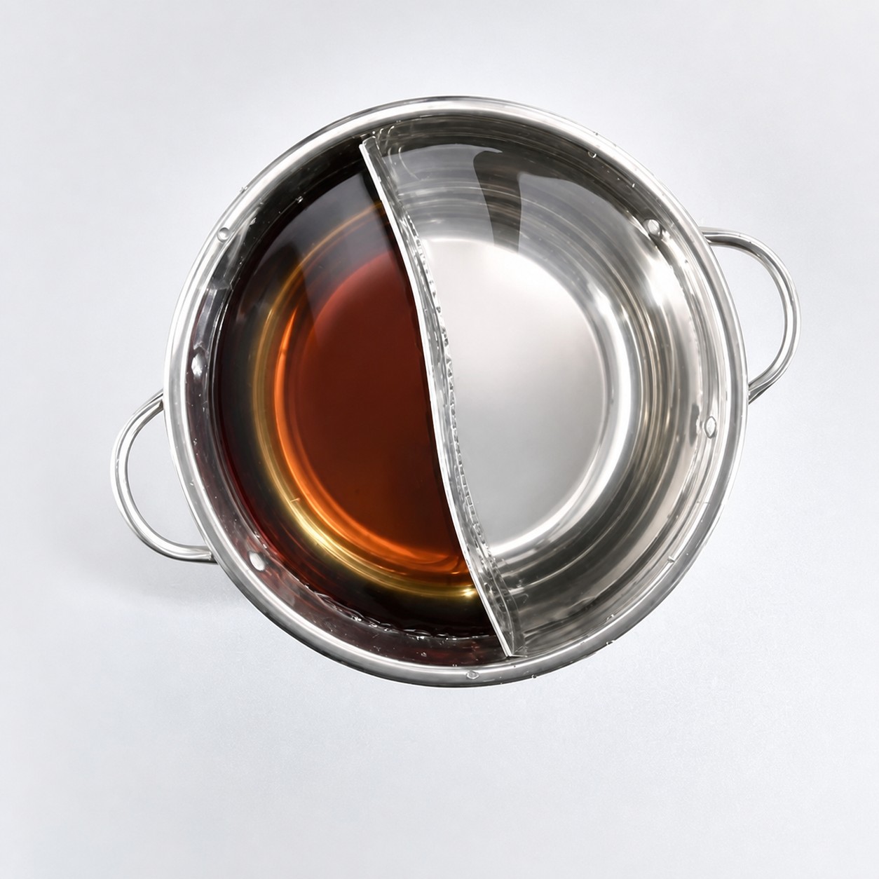Stainless steel divided hot pot in use