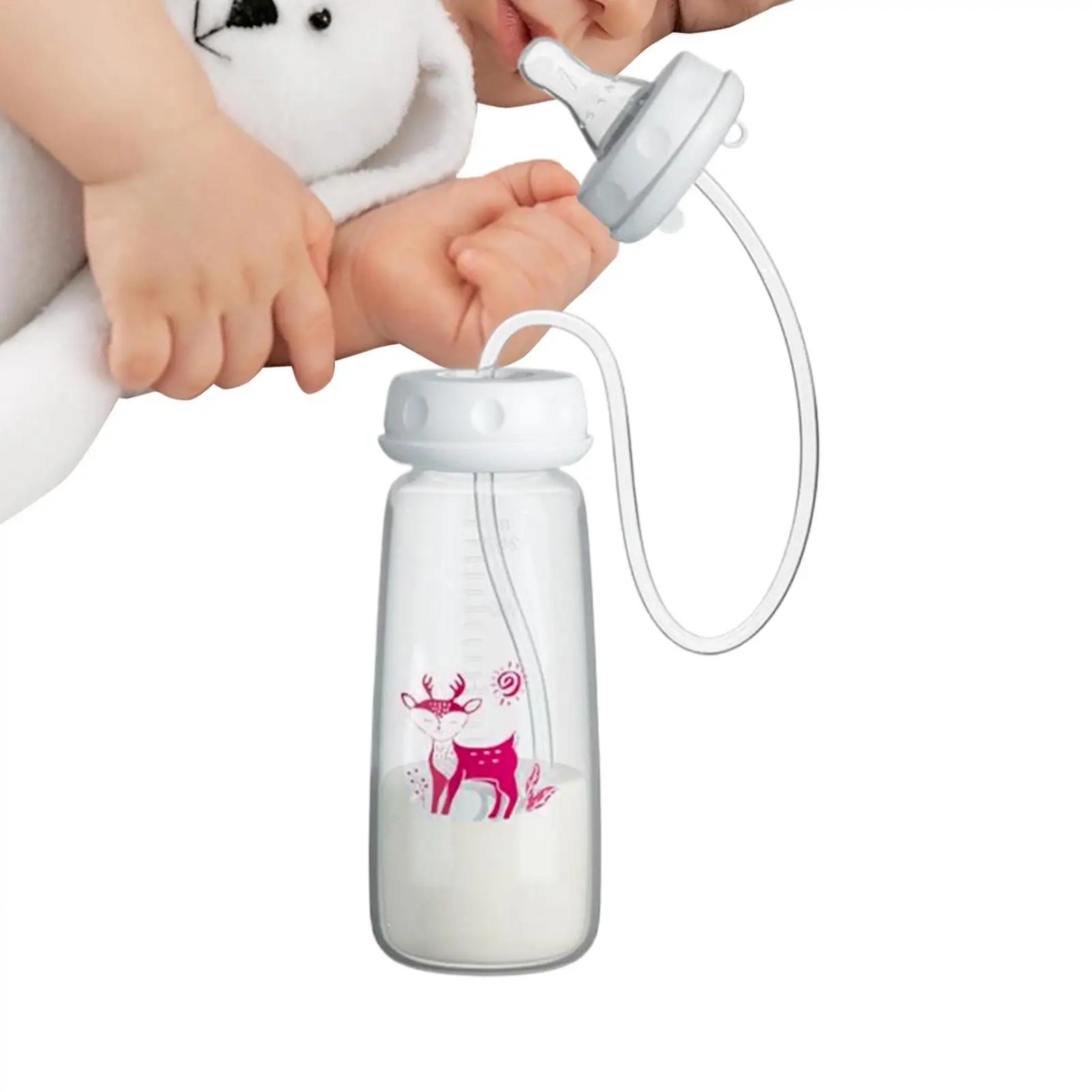 Baby using the hands-free feeding nipple with a caregiver nearby