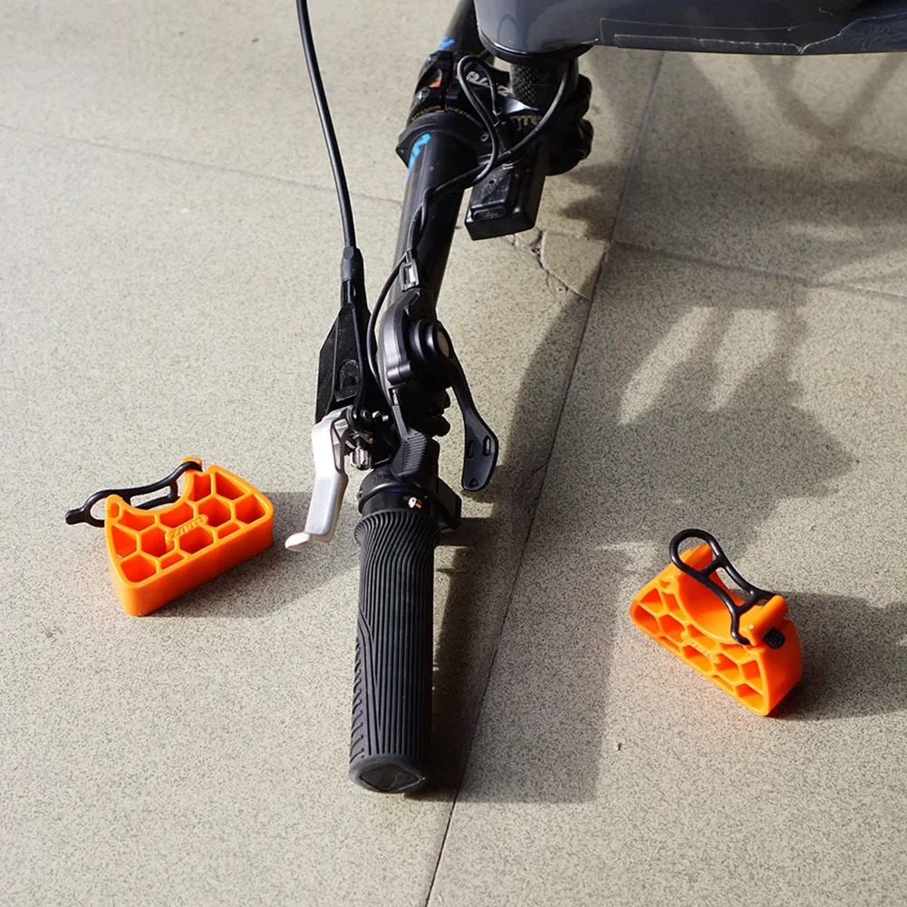 Pair of bike handlebar stabilizer stands beside an inverted handlebar