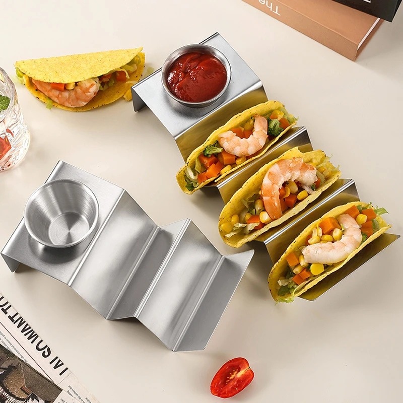 Stainless steel taco holders serving filled tacos with sauce bowls
