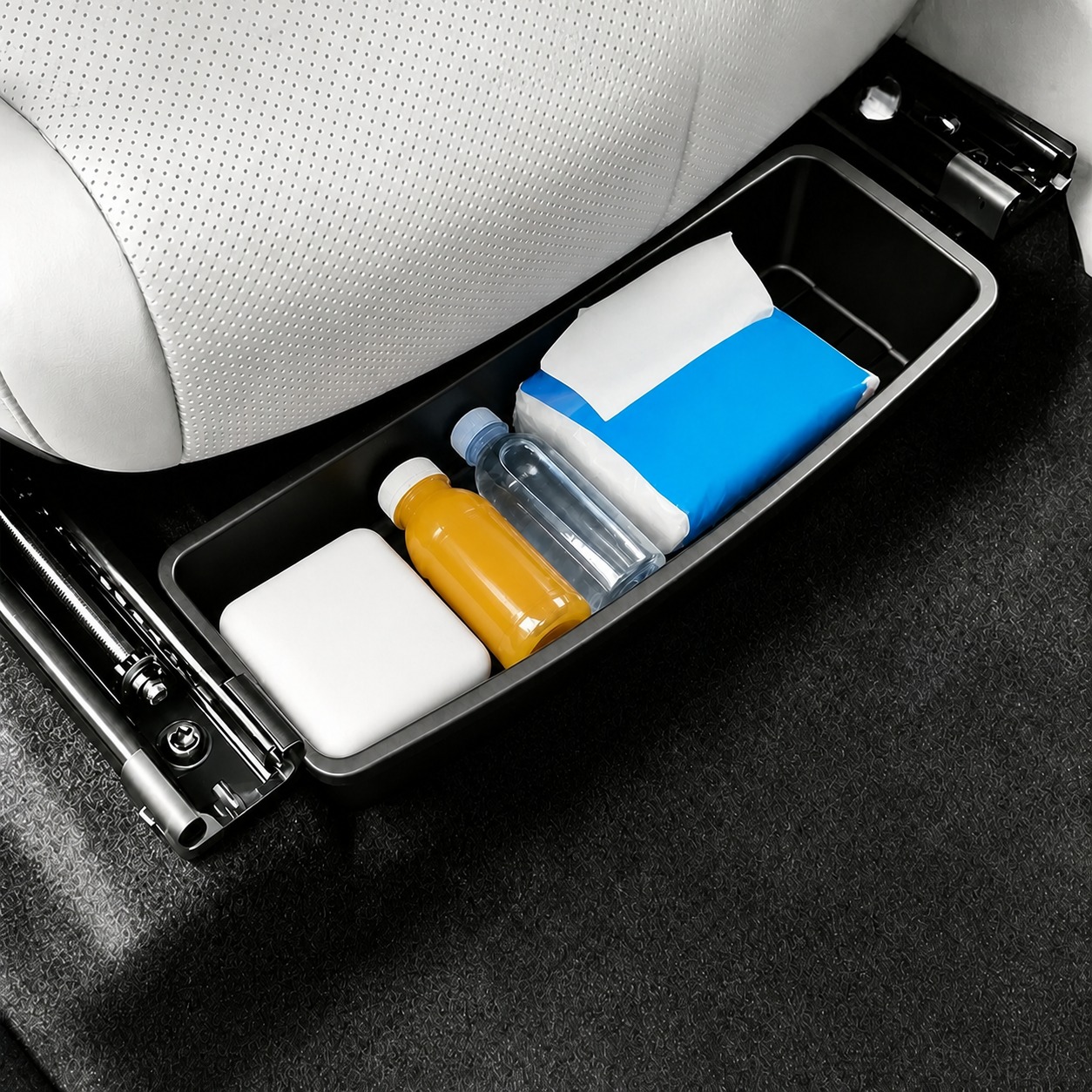 Black car under-seat storage box holding everyday travel items