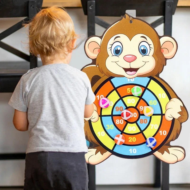 Child throwing a sticky ball at a monkey scoring target